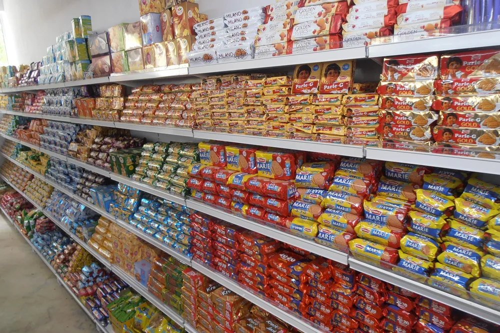 Long, neatly organised biscuit aisle in an Indian hypermarket